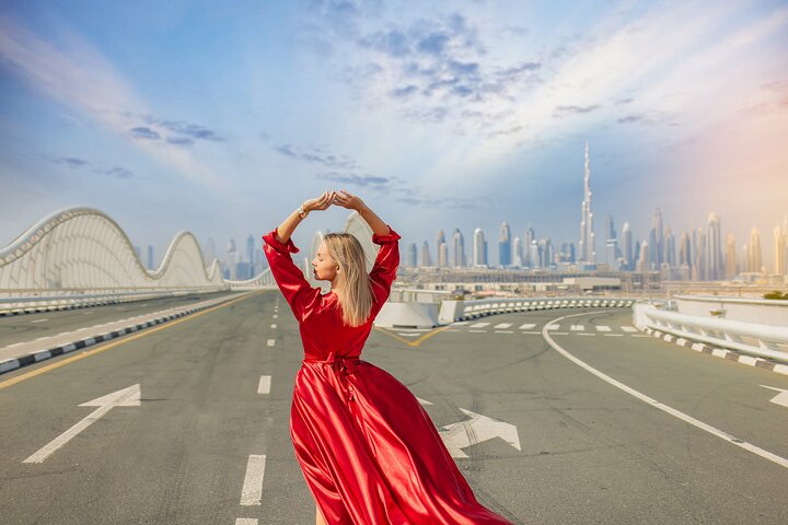 Twirl against the stunning backdrop of Dubai's skyline in a flowing dress capturing moments that blend elegance and the city's iconic landmarks for unforgettable memories.